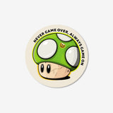 An extra‑life mushroom matte vinyl sticker with text "Never Game Over, Always Game On"